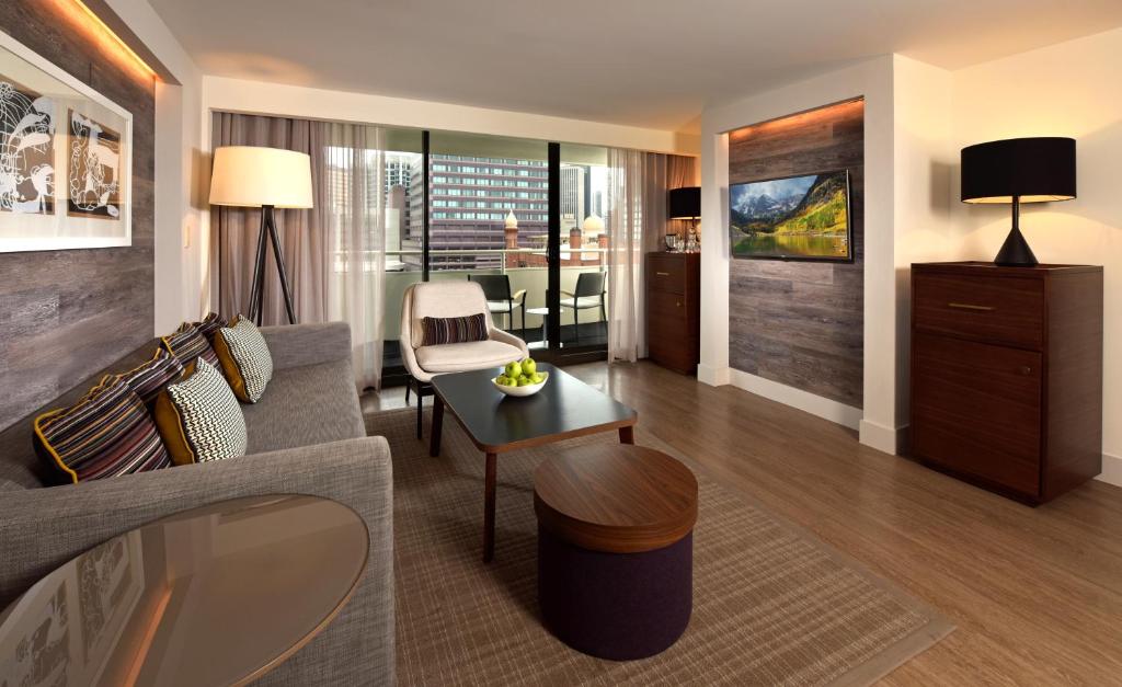 Warwick Denver Apartment with sofa and TV